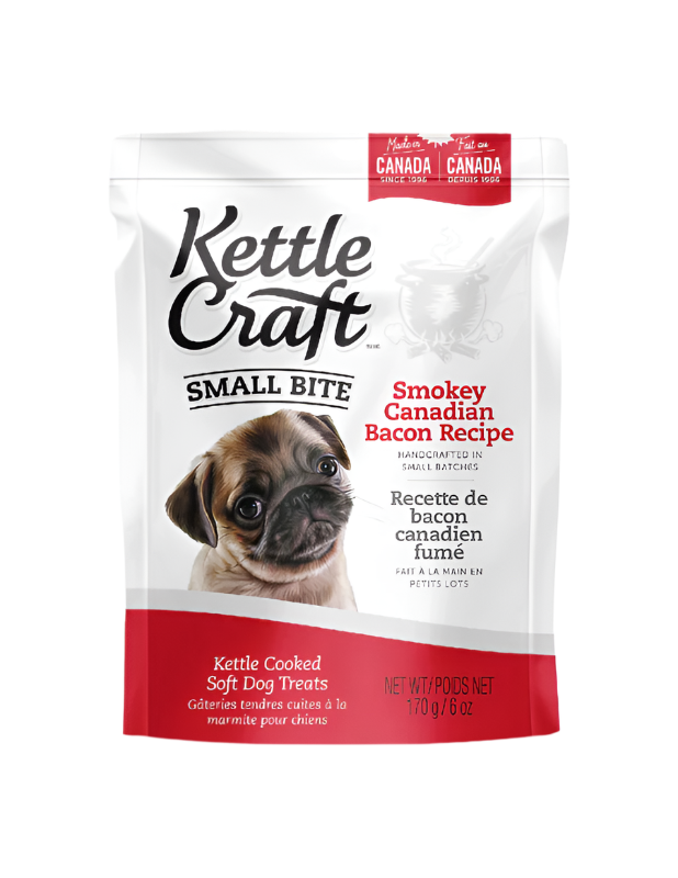 A package of Kettle Craft Small Bite Dog Treats with Smokey Canadian Bacon flavor. The package is predominantly white, with images of the product and a dog on the front.