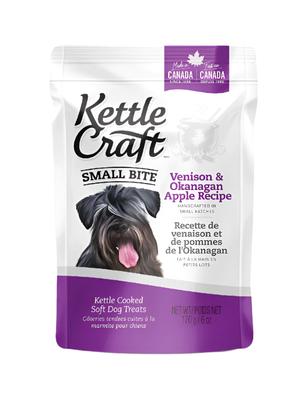 A package of Kettle Craft Small Bite dog treats with Venison & Okanagan Apple recipe. The package is predominantly white with images of a dog and product information.